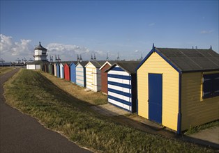 Colourful seaside beach huts and Low lighthouse maritime museum, Harwich, Essex, England, United