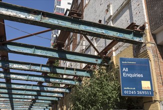 Savills estate agent sign All Enquiries on derelict factory building, Wet Dock, Ipswich, Suffolk,