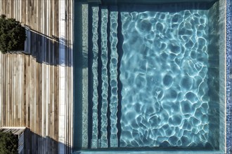 AI generated aerial view perpendicular top down of an wooden deck with a swimming pool at daylight