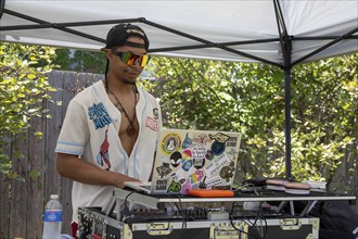 Detroit, Michigan, A DJ plays music at the annual 'Summer Sizzler' picnic and party held by two