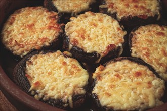 Portabello mushrooms stuffed with suluguni cheese in a clay pan, ketsi, Georgian cuisine, hot