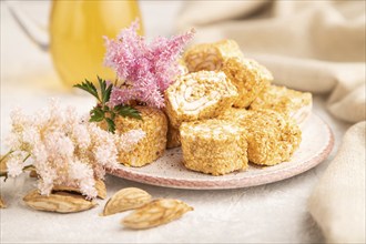 Traditional turkish delight (rahat lokum) with glass of green tea on a gray concrete background and