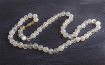 Agate colored beads on a black background. top view, close up