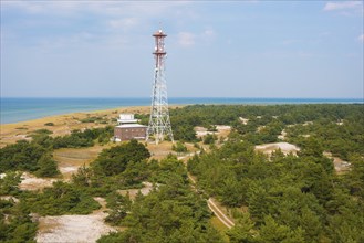 Marine radio tower, sandy coastal landscape with sandy beach, dunes and sparse vegetation, sand