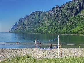 Beach Ersfjordstranden, fjord Ersfjord, public recreation area, summer, people go swimming, view to