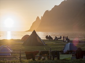 Beach Ersfjordstranden, fjord Ersfjord, people sitting in small groups at the beach, public