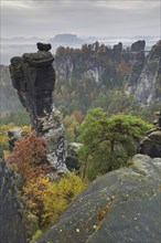 View over the rock tower Wehlnadel and the valley Wehlgrund in autumn, Saxon Switzerland,