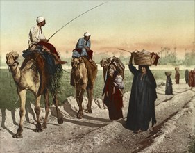 Cairo, farmers and woman on their way home from the fields, Egypt, digitally restored reproduction