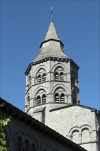 Orcival. Bell tower of the Notre-Dame d'Orcival basilica showcasing Romanesque architecture under a