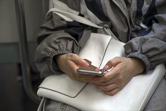 Hands with Iphone of a young woman, Genoa, Italy, Europe