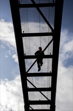 Lattice walkway, people walk over a walkway at a height of a good 15 metres, made of steel lattice,