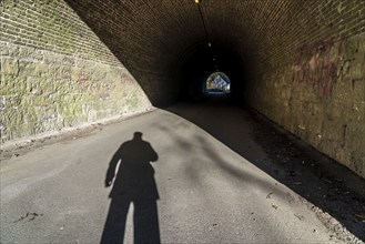 Shadow of a person, man, at the beginning of a tunnel, symbolic image