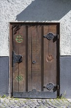 Old wooden door on a historic half-timbered building in the old town of Ulm, Baden-Württemberg,