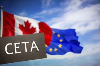 Sign reading CETA in front of the flags of Canada and the European Union. The abbreviation CETA