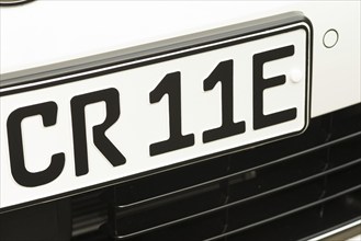 Black and white vehicle registration plate, licence plate, registration number of an electric car