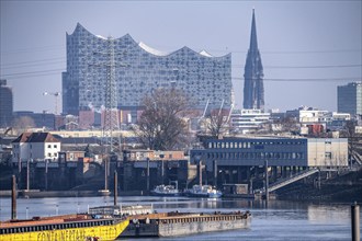 Hamburg harbour, Travehafen, water police station 2, working boats and barges, jetty, city skyline