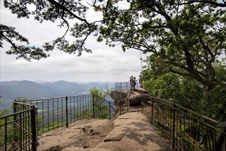 Hikers on the Orensfels summit plateau in the Palatinate Forest, Germany, Europe