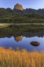 Mountain reflected in lake, autumn, morning light, sunny, Vesteralen, Norway, Europe