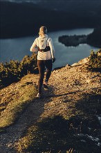 Trail running in autumn on the Jochberg on Lake Walchensee against the wonderful backdrop of the