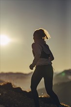 Trail running in autumn on the Jochberg on Lake Walchensee against the wonderful backdrop of the