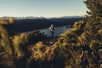 Trail running in autumn on the Jochberg on Lake Walchensee against the wonderful backdrop of the