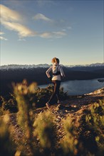 Trail running in autumn on the Jochberg on Lake Walchensee against the wonderful backdrop of the