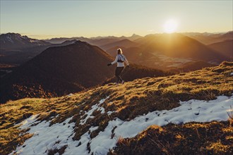 Trail running in autumn on the Jochberg on Lake Walchensee against the wonderful backdrop of the