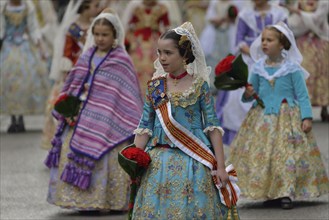 Fallas festival, girls in a traditional costume during the parade in the Plaza de la Virgen de los