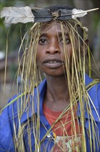 Musician with a headdress made of bast and a feather, Nkala, Bandundu Province, Democratic Republic