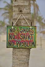 Sign "No shoes, no shirt, no problem" on the beach of Salalah Rotana Resort, Salalah, Dhofar