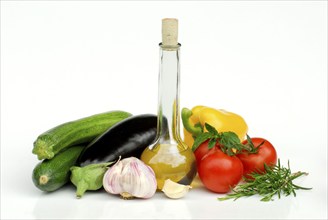 Ingredients for ratatouille, zucchini, aubergines, garlic, olive oil, tomatoes, rosemary, basil