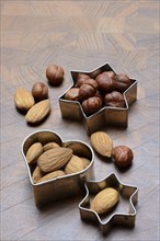 Nuts and cookie cutters, almonds and hazelnuts