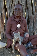 Traditional healer, Himba, holding a cat, Omohanja, Kaokoland, Kunene, Namibia, Africa