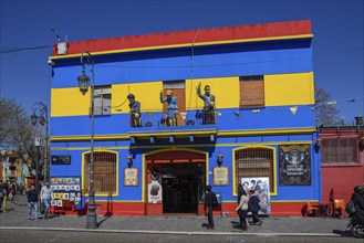 Colourful house facade, on the balcony footballer Diego Maradona, folk heroine Eva Perón and tango