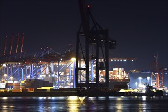 Container ships being loaded at night at the container terminal Burchardkai, Hamburg, Germany,