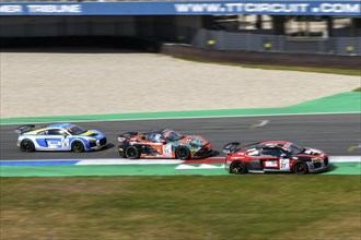 Three race cars sports car in the back front Audi R8 LMS GT4 with Porsche Cayman GT4 Clubsport