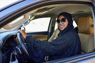 Veiled woman driving a car, AlUla, Medina Province, Saudi Arabia, Arabian Peninsula, Asia