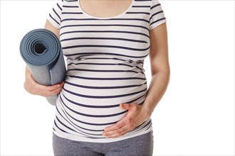 Pregnancy yoga concept, pregnant woman standing with yoga mat close up isolated on white background