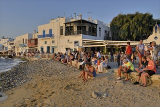 Tourists watching the sunset in Little Venice, Chora or Mykonos Town, Mykonos, Cyclades, Greece,