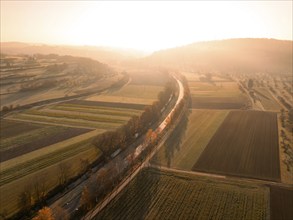 Aerial view of fields and streets in the light of an autumn sunset with light fog, Weil der Stadt.