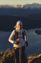 Trail running in autumn on the Jochberg on Lake Walchensee against the wonderful backdrop of the