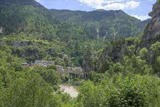 View of the village of Saint Chely with bridge and waterfall, Gorges du Tarn Causses, Département