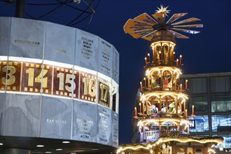 A Christmas pyramid behind the World Time Clock at the Christmas market on Alexanderplatz, Berlin,