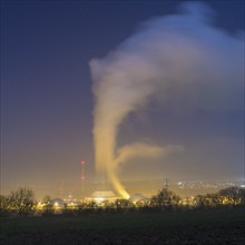 Industrial environment at night with rising clouds of smoke, Neckarwestheim nuclear power plant,