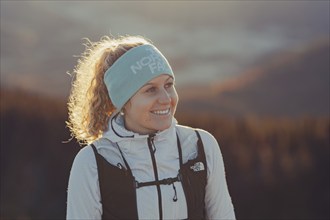 Trail running in autumn on the Jochberg on Lake Walchensee against the wonderful backdrop of the