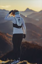 Trail running in autumn on the Jochberg on Lake Walchensee against the wonderful backdrop of the