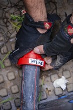 Close-up of hands in work gloves assembling a pipe with a tool, fibreglass assembly, Calw district,