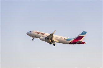 A Eurowings aircraft rises into the blue sky, symbolising the start of a journey,