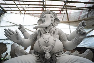 Artisan work on idols of the elephant-headed Hindu deity Ganesha at a workshop ahead of the Ganesh