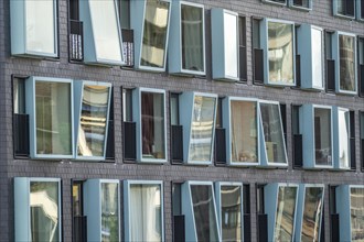 Box-shaped windows, at different angles, façade of a residential building in Rotterdam, Netherlands